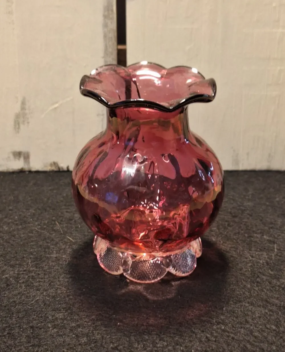 Vintage med century cranberry vase. Thumbprint base and ruffed top.
